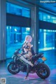 A woman sitting on top of a motorcycle in a room.