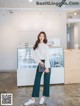 a woman standing in front of a counter in a store